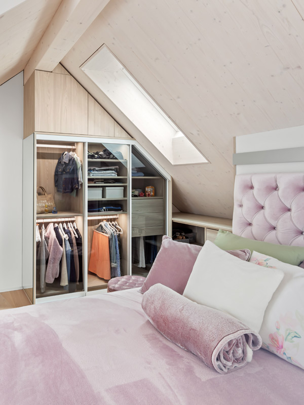 Maßgefertigter Dachschrägen Kleiderschrank mit Glastüren und Holzdekor im Schlafzimmer verbaut
