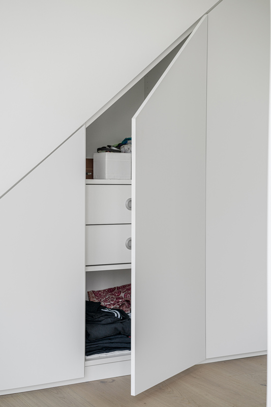 Weißer Nischenschrank unter der Schräge